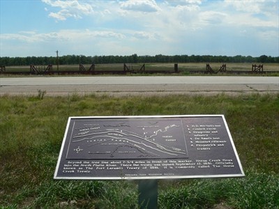 A metal plaque with text and a map.