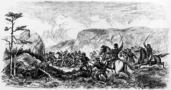 black and white image of men leading a cavalry charge against native american civillians in a narrow gorge