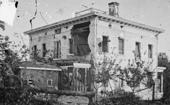 a home that has bullet holes and cannon ball cracks