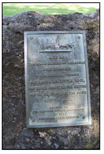 a plaque attached to a large stone