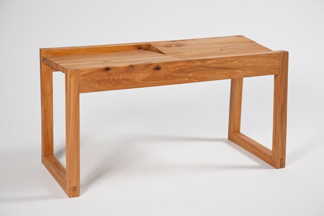 Wooden bench, with two legs on each side but they are connected