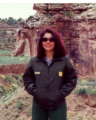 Women in NPS uniform standing in front of a rock formation.