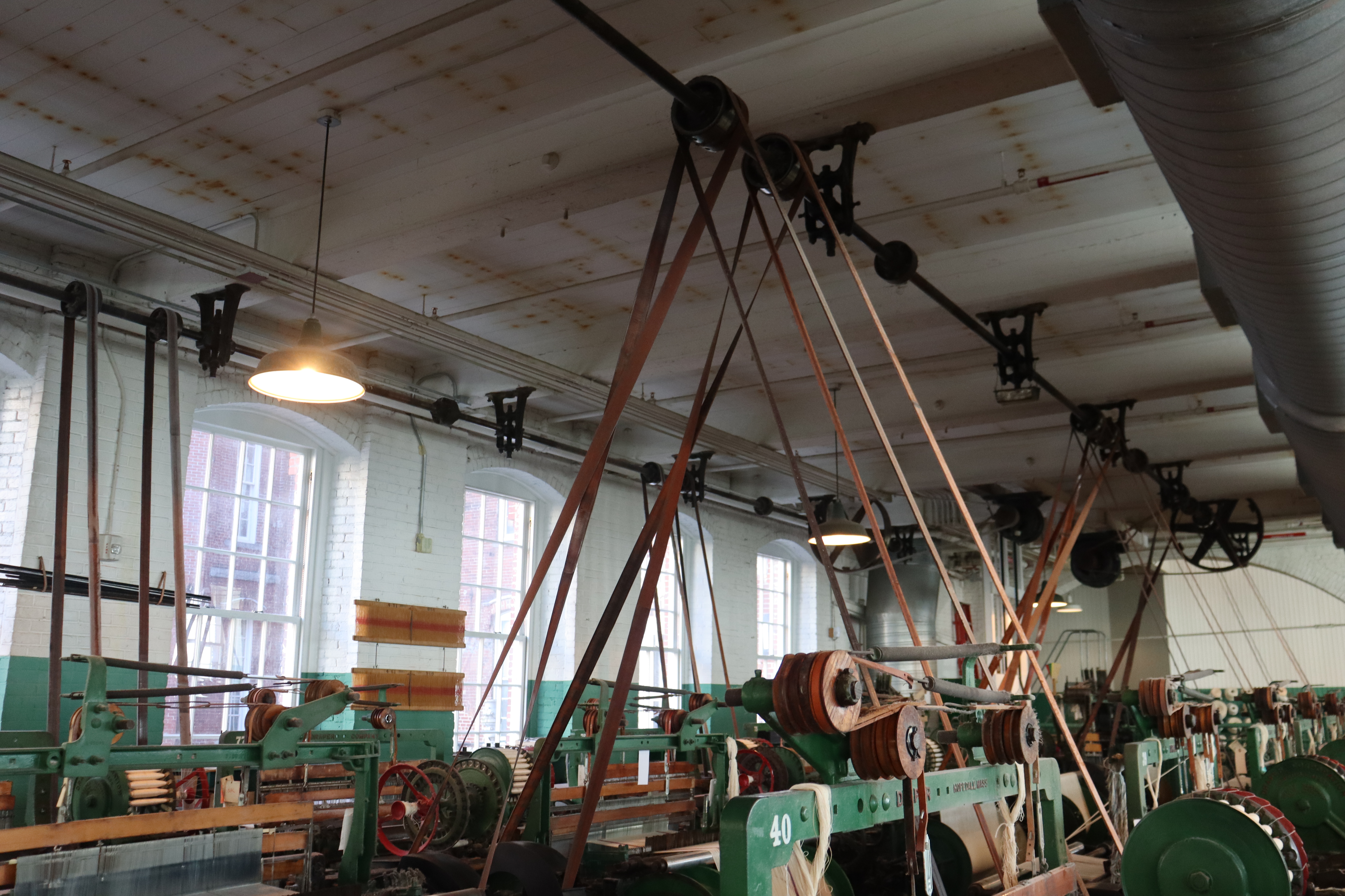 Circular metal structure holding bobbins of thread