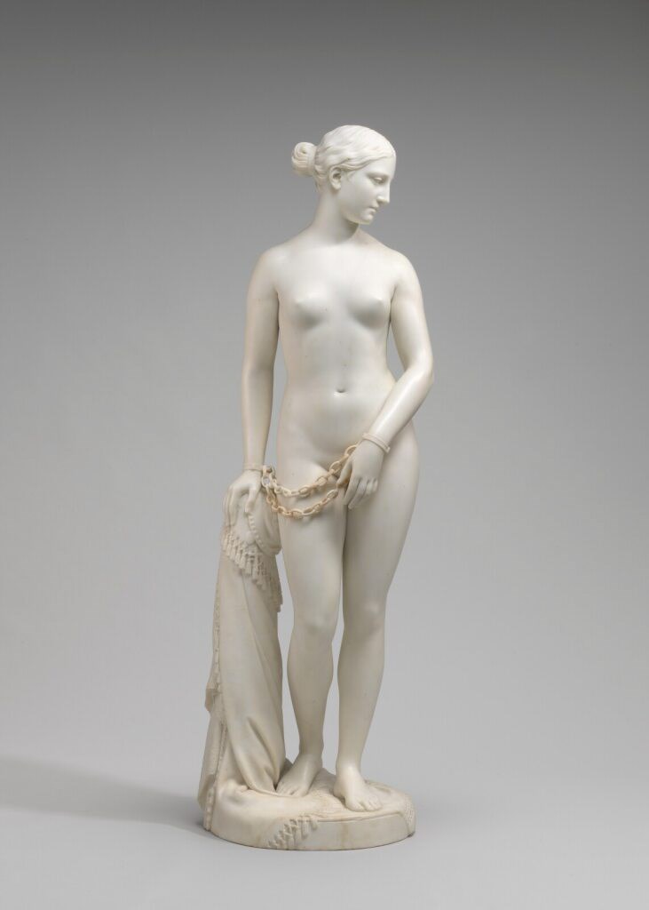 The Greek Slave by Hiram Powers, full sculpture of woman in white marble with hands in chains