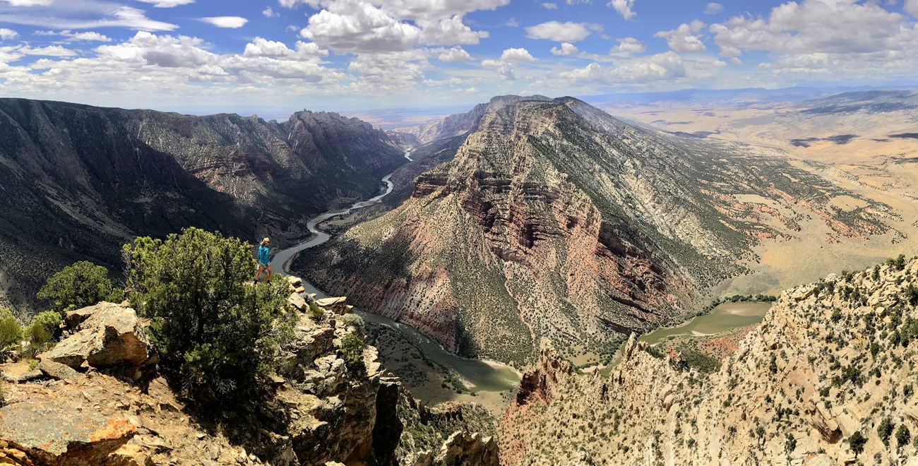 Overlook at Ruple Point with hiker and view of Green River winding through Dinosaur National Monument.