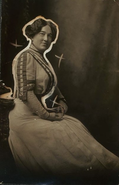 A woman in a long dress against a blank background