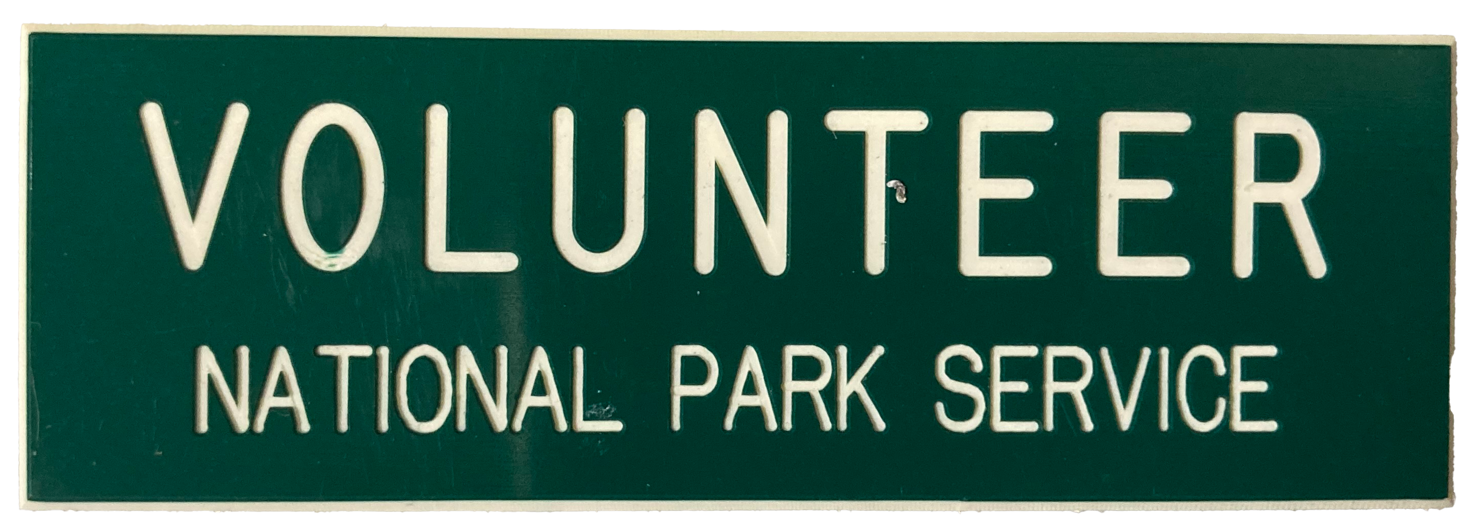 Green tag with Volunteer in white letters