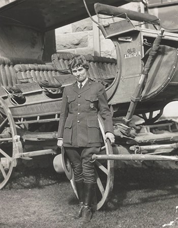 Ranger-naturalist Herma Albertson stands in front of a large buggy.