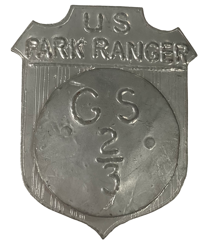 Silver shield shaped park ranger badge marked GS2/3