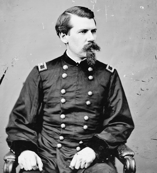 Black and white portrait of a man in Civil War uniform and a goatee.