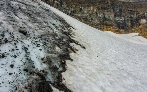 snow and ice with rockes behind