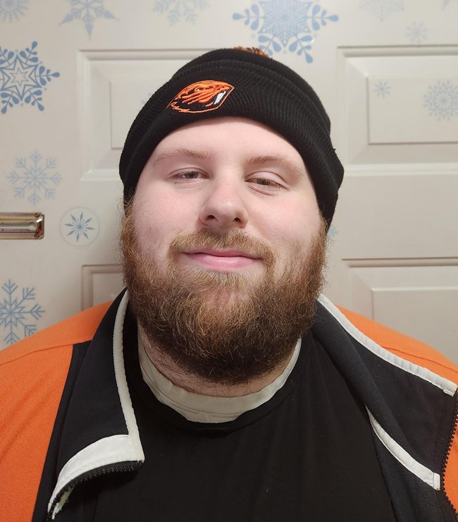 A man with a beard wearing a black beanie