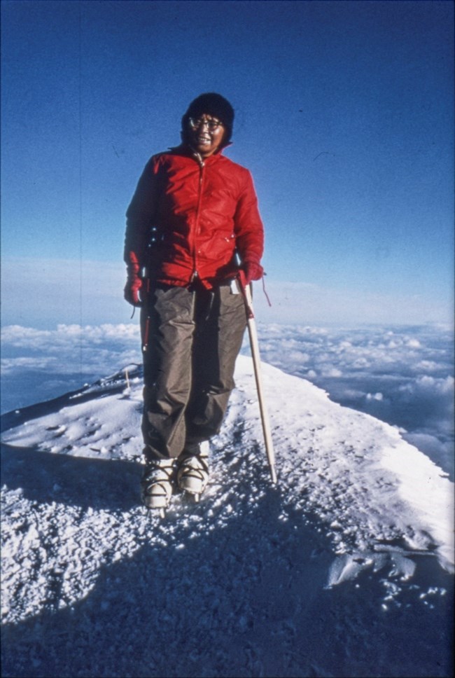 a woman standing on a snowy mountaintop