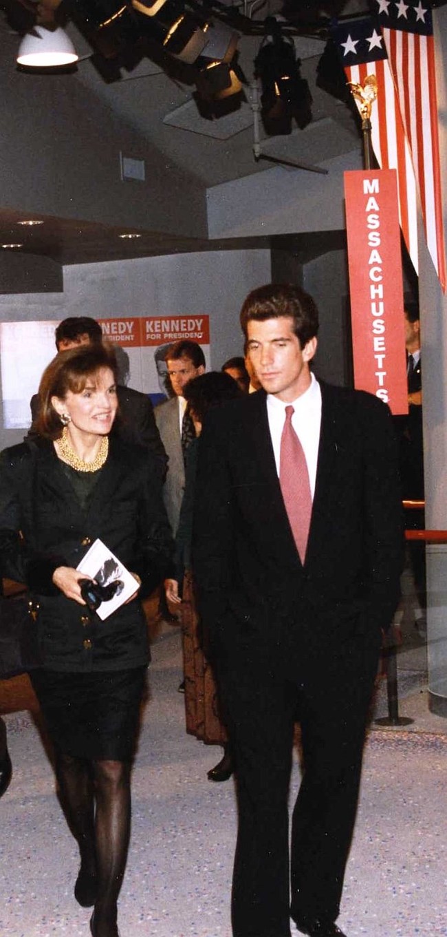 Jackie Kennedy and John Kennedy Jr. walk through the Kennedy Library Museum