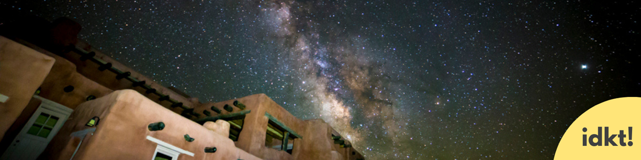 a building under a brilliant night sky with the milky way visible