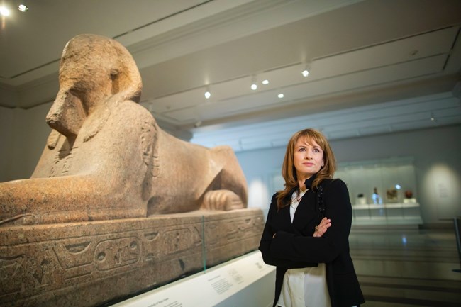 Lynn Meskell, PIK Professor, University of Pennsylvania beside a sphinx exhibit.
