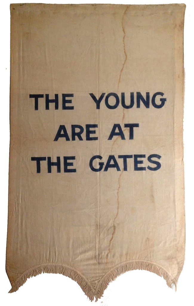 silk banner with the words "The Young Are At the Gates" in capital letters