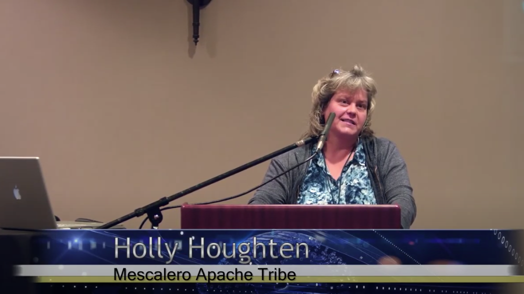 Holly Houghten, Mescalero Apache Tribe, speaks at a lectern at the Texas Cultural Landscapes Symposium.