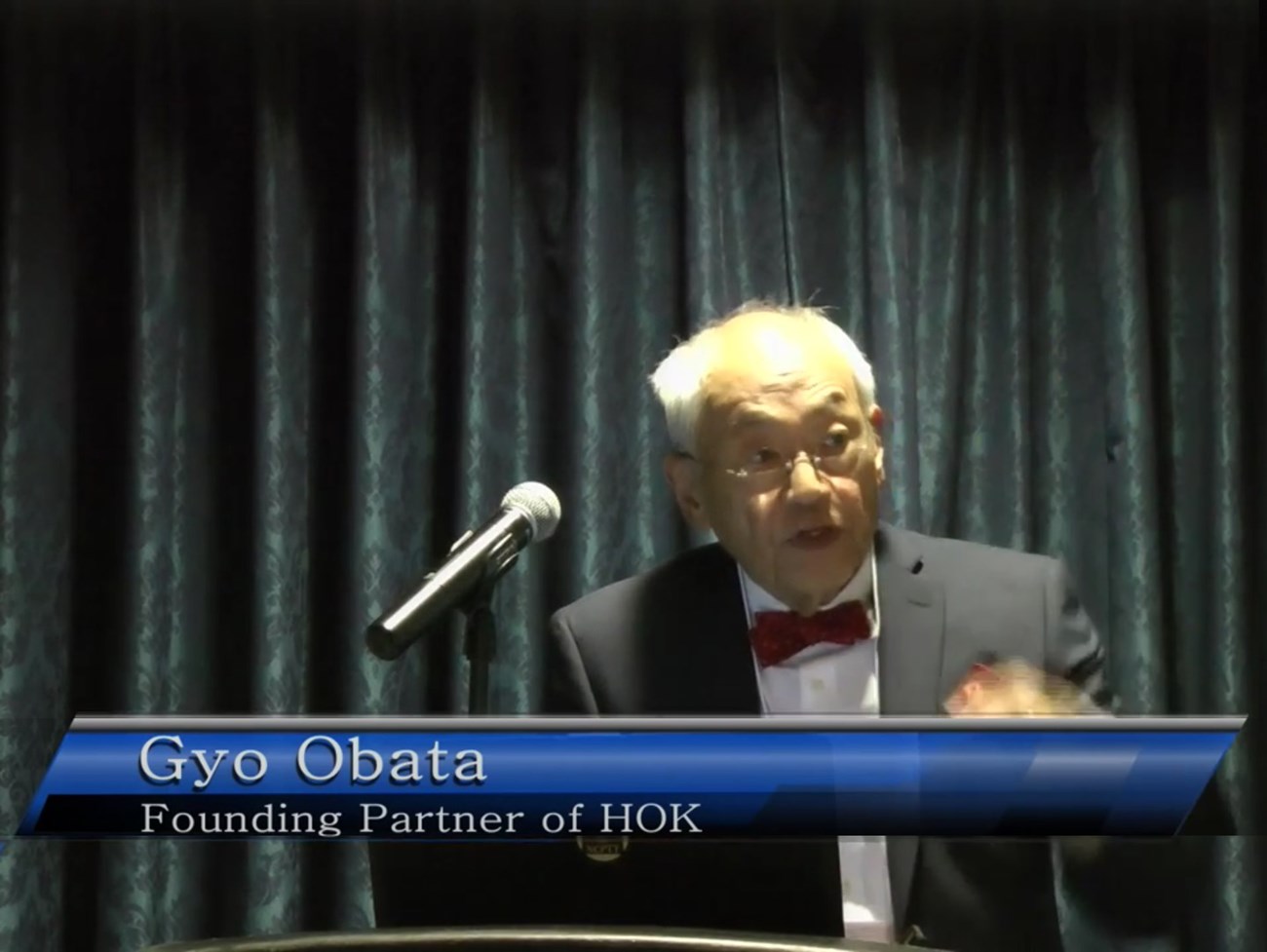 Photo of the presenter at a lectern.