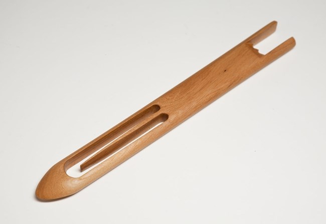 Piece of wood in shape of the point of a knife, with a hollow section at the end