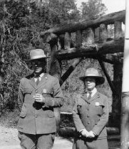 Tex and Irene Wisdom stand posing in the NPS uniforms. She wears a skirt instead of breeches.