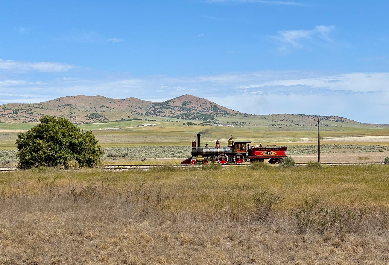 Replica locomotive at Golden Spike NHP, surrounded by sagebrush, grasses, and shrubs.