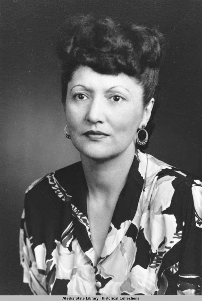 portrait style photo of a woman dressed in a floral print dress