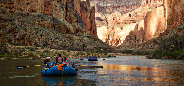 Two blue rafts float through the Grand Canyon on the Colorado River