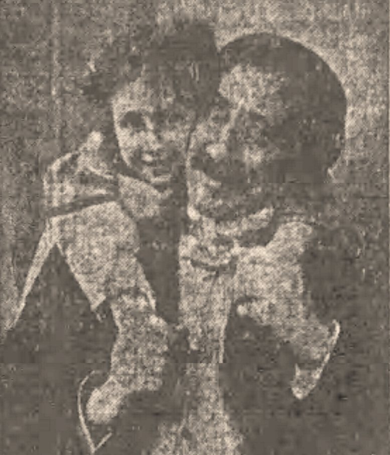 grainy historic photo of a smiling man with a little girl hugging him