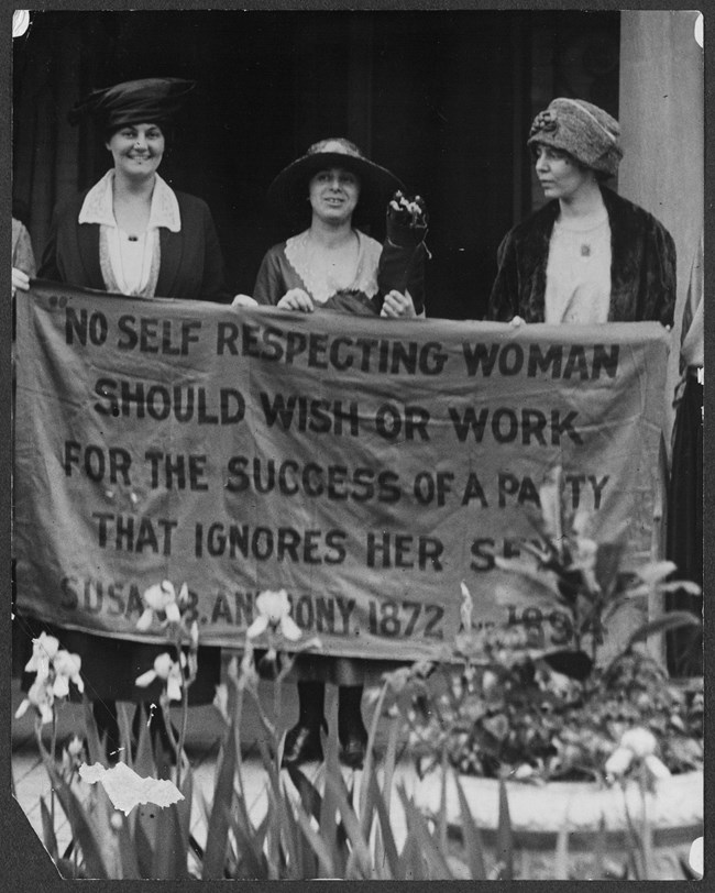 Women holding banner.