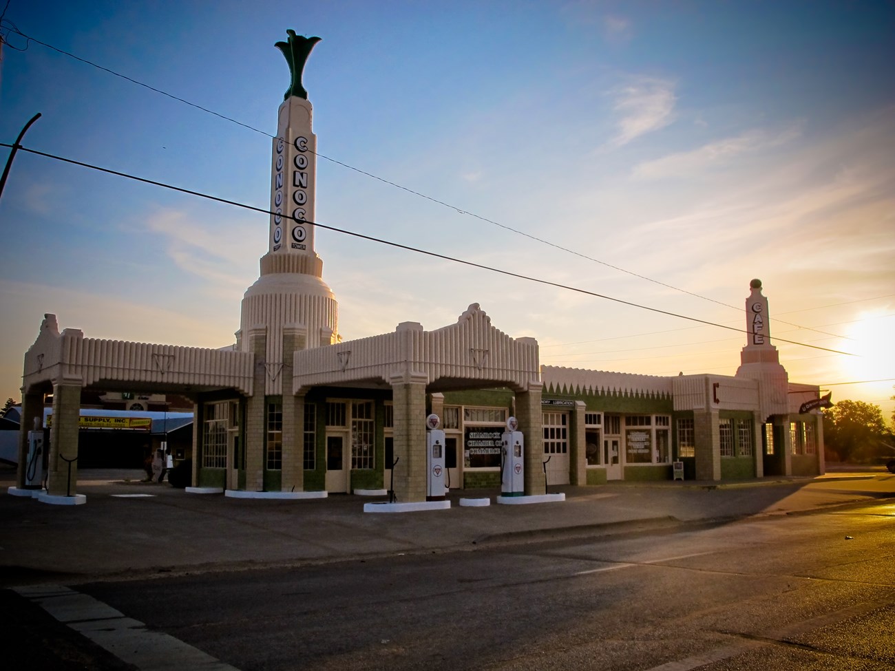 A white building with a tall tower that reads "CONOCO" vertically.