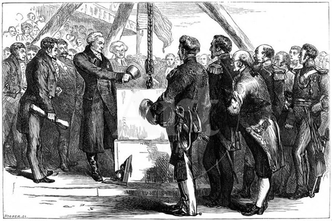 Black and white illustration of a group of men hoisting a block of marble into place