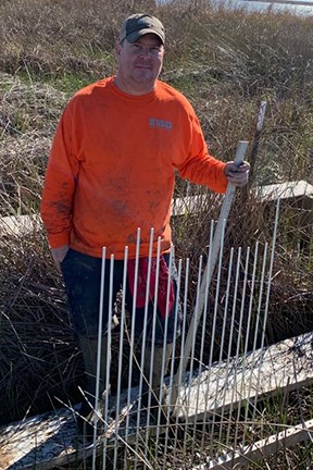man on a platform in a marsh