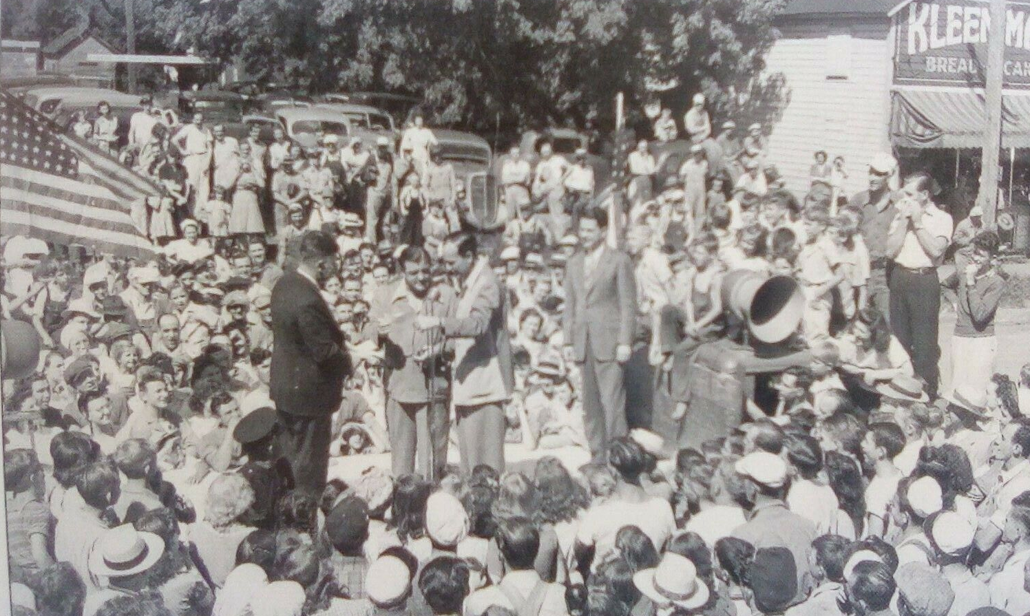 large crowd gathered outside around stage to hear performers