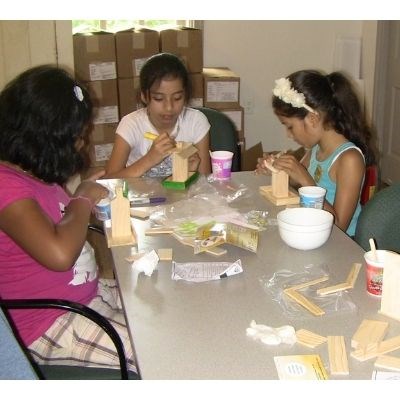 Youth doing arts and crafts at a table.