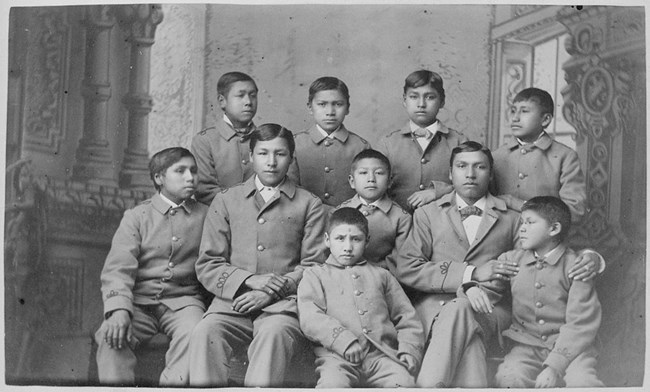 Group of boys in cadet uniforms as the carlisle indian school