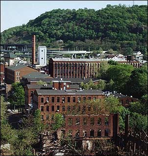 Photo of brick buildings surrounded by trees.