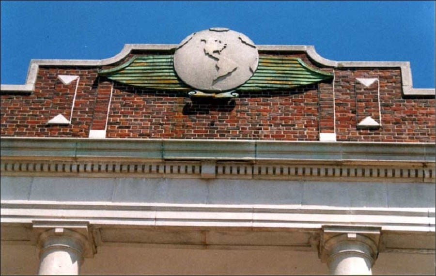 Top part of Ryan Visitor Center at Floyd Bennett Field, showing emblem of a stylized globe seal, 2002.(Floyd Bennett Field Task Force)