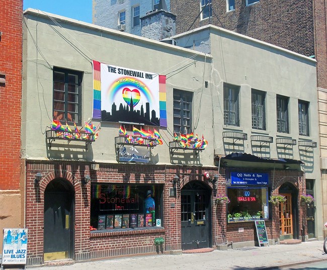 Exterior of the Stonewall Inn with Rainbow flags