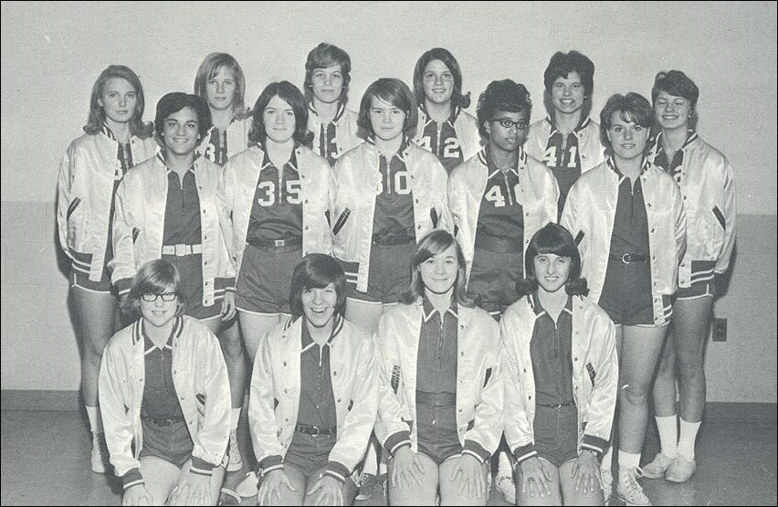 High school girls in basketball uniforms. All of them are white except for one black player, Cynthia Gaines.