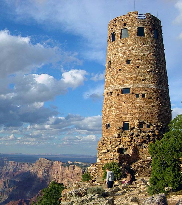 a circular stone tower 5 stories high with windows of different sizes around the circumference