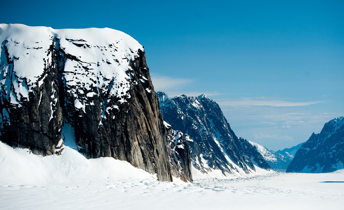 mountains towering over a glacier