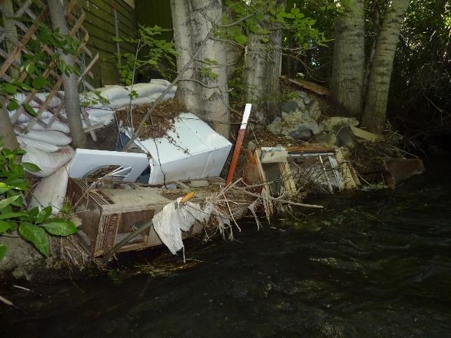 Debris along the bank before restoring Bozeman Creek. Photo courtesy of the Greater Gallatin Watershed Council.