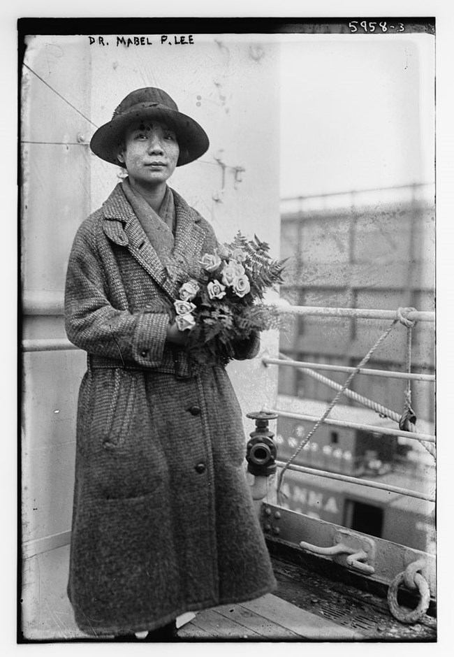 Photo of a woman holding flowers. Library of Congress.