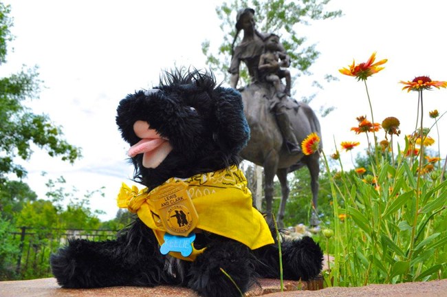 toy dog with statue in the background