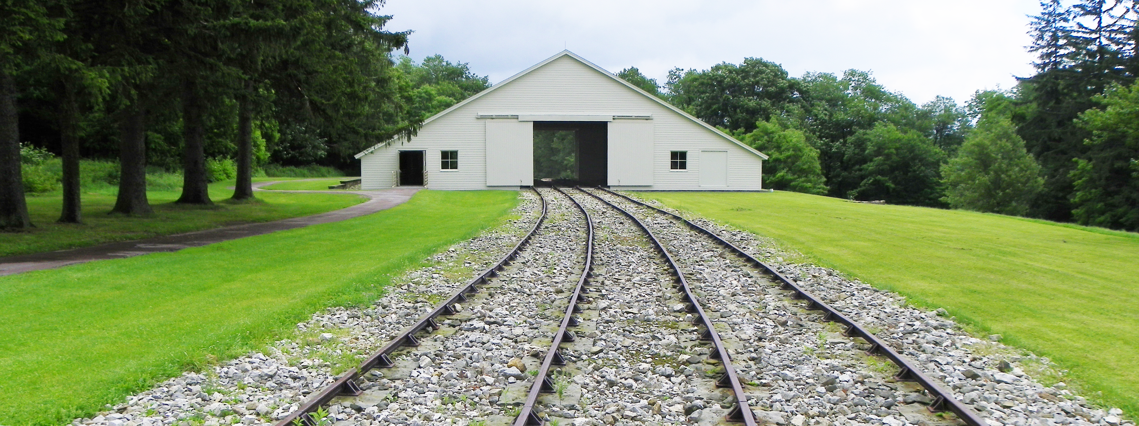 A railroad extending into the distance through an engine house.