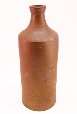 A matted texture, brown bottle made of clay.