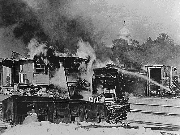 Destroyed buildings burn. The US Capitol dome looms in the background.