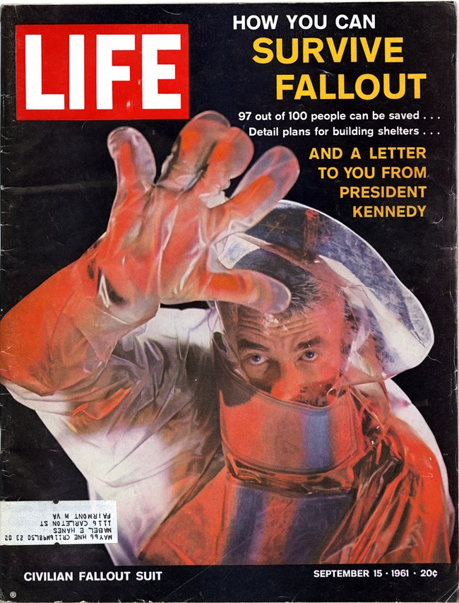 Photograph of a Time Magazine cover showing a man in a radiation suit