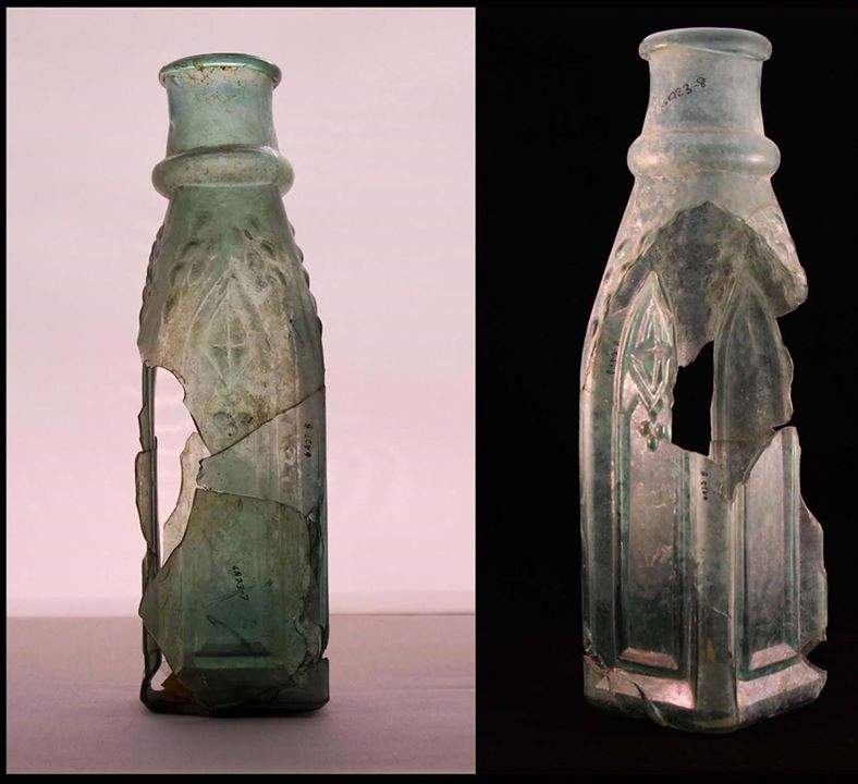 Front and back of a cloudy, cracked, glass pickle bottle.